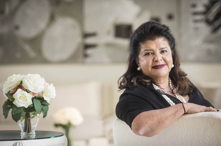 Imagem mostra Luiza Trajano sentada em uma poltrona, olhando para a camêra