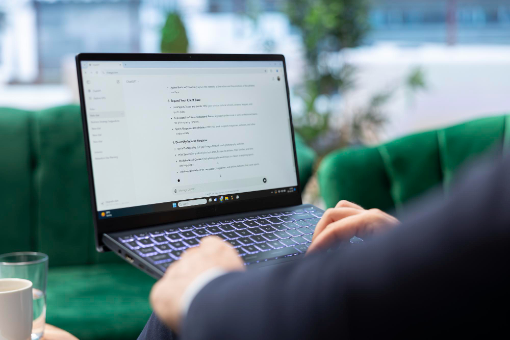 Profissional utilizando inteligência artificial no notebook para apoiar tarefas e aumentar a produtividade.